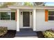 Close-up of the front entrance with gray door, sidelights, and decorative wood shutters at 974 Shirley Se St, Smyrna, GA 30082