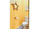 Powder room with a yellow painted walls and star-shaped mirror at 130 Arizona Ne Ave # 415, Atlanta, GA 30307