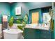 Modern bathroom featuring a vessel sink, plants, and sleek green cabinetry at 130 Arizona Ne Ave # 415, Atlanta, GA 30307