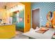 A funky kitchen with yellow lower cabinets, overhead track lighting, and stainless steel appliances at 130 Arizona Ne Ave # 415, Atlanta, GA 30307