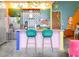 Bright eclectic kitchen featuring an island with seating, unique tile backsplash, and modern appliances at 130 Arizona Ne Ave # 415, Atlanta, GA 30307
