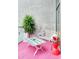 Cozy outdoor patio area with pink rug, concrete wall, stylish furniture, and natural light at 130 Arizona Ne Ave # 415, Atlanta, GA 30307