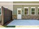 Backyard patio area with fenced in yard and view of the rear exterior with door and windows at 1616 Ruskin Way, Marietta, GA 30062