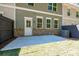 Home's backyard featuring patio and lawn, exterior with a door, windows, and siding at 1616 Ruskin Way, Marietta, GA 30062