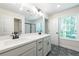 Bright bathroom features double sinks, granite countertops, modern fixtures, and decorative flooring at 1616 Ruskin Way, Marietta, GA 30062