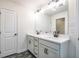 Bright bathroom features double sinks, granite countertops, modern fixtures, and decorative flooring at 1616 Ruskin Way, Marietta, GA 30062