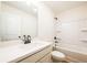 Bright bathroom with a single sink vanity and a shower/tub combo with shelving at 1616 Ruskin Way, Marietta, GA 30062