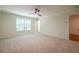 Bright bedroom with plush carpet, ceiling fan, large window, and access to the en-suite bathroom at 1616 Ruskin Way, Marietta, GA 30062