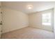 Empty bedroom featuring neutral carpet and paint with a large window providing natural light at 1616 Ruskin Way, Marietta, GA 30062