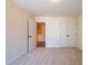 Carpeted bedroom with two closets, neutral paint, and a view into an adjacent room at 1616 Ruskin Way, Marietta, GA 30062