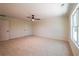 Large bedroom with plush carpet, ceiling fan, and natural light from the large window at 1616 Ruskin Way, Marietta, GA 30062