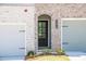 Home exterior showcases a brick facade, covered entry, and a well-maintained lawn at 1616 Ruskin Way, Marietta, GA 30062