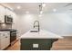 Modern kitchen features a center island, quartz countertops, stainless steel appliances, and updated fixtures at 1616 Ruskin Way, Marietta, GA 30062