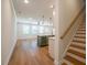 Bright, open concept with hardwood floors, a kitchen island, and stairway at 1616 Ruskin Way, Marietta, GA 30062