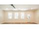 Bright living room featuring hardwood floors, modern light fixtures, and an open floor plan into the kitchen at 1616 Ruskin Way, Marietta, GA 30062