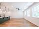 Bright living room featuring hardwood floors, modern light fixtures, and an open floor plan into the kitchen at 1616 Ruskin Way, Marietta, GA 30062