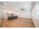 Bright living room featuring hardwood floors, modern light fixtures, and an open floor plan into the kitchen at 1616 Ruskin Way, Marietta, GA 30062