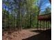 Backyard featuring a deck with wooded views on a sunny day at 501 Woodland Trce, Woodstock, GA 30189