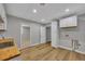Basement kitchenette with white cabinets, butcher block countertop and durable wood-look flooring at 501 Woodland Trce, Woodstock, GA 30189