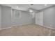 Basement featuring neutral carpet, windows and double doors for additional rooms at 501 Woodland Trce, Woodstock, GA 30189
