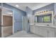 Inviting bathroom featuring double sinks, a walk-in shower, and blue walls at 501 Woodland Trce, Woodstock, GA 30189