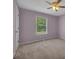 Cozy bedroom featuring soft carpet, a ceiling fan and a window with natural light at 501 Woodland Trce, Woodstock, GA 30189