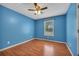 Bright bedroom featuring wood-look floors, blue walls, and natural light from a window at 501 Woodland Trce, Woodstock, GA 30189
