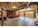Spacious garage area with overhead lighting, a red car, and ample storage space at 501 Woodland Trce, Woodstock, GA 30189