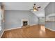 Open living room with wood floors, a brick fireplace, and great natural light that flows through to the breakfast bar at 501 Woodland Trce, Woodstock, GA 30189