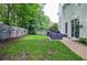 A well-manicured lawn with patio furniture and a beautiful garden at 521 Mirramont Pl, Woodstock, GA 30189