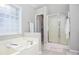 Cozy bathroom with soaking tub and a glass-enclosed shower at 521 Mirramont Pl, Woodstock, GA 30189