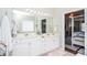 Bright bathroom featuring double vanity, large mirror, and modern lighting at 521 Mirramont Pl, Woodstock, GA 30189