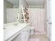 Well-lit bathroom featuring a decorative flamingo shower curtain and white vanity at 521 Mirramont Pl, Woodstock, GA 30189