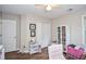 Bright bedroom featuring hardwood floors, double closet, and ample natural light from the window at 521 Mirramont Pl, Woodstock, GA 30189