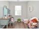 Bright bedroom featuring a charming vanity and natural light at 521 Mirramont Pl, Woodstock, GA 30189