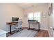 Bright office space with modern desks, chair, and natural light; perfect for working from home at 521 Mirramont Pl, Woodstock, GA 30189