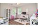 Bright bedroom featuring a desk, a ceiling fan and natural light at 521 Mirramont Pl, Woodstock, GA 30189