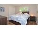 Cozy bedroom featuring neutral paint, hardwood floor and natural light from the window at 521 Mirramont Pl, Woodstock, GA 30189