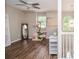 Bonus room with hardwood floors, ceiling fan, and staircase at 521 Mirramont Pl, Woodstock, GA 30189