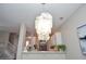 Bright dining area with chandelier lighting, open to kitchen and staircase at 521 Mirramont Pl, Woodstock, GA 30189