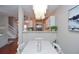 View of dining area leading into kitchen, featuring chandelier lighting and staircase at 521 Mirramont Pl, Woodstock, GA 30189