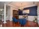 Elegant dining room featuring hardwood floors, a chandelier, and views into other living spaces at 521 Mirramont Pl, Woodstock, GA 30189