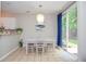 Elegant dining area with light-filled space and a stylish chandelier, perfect for Gathering meals and entertaining at 521 Mirramont Pl, Woodstock, GA 30189