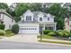 Charming two-story home featuring a two-car garage, well-manicured landscaping, and inviting curb appeal at 521 Mirramont Pl, Woodstock, GA 30189