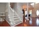 Spacious foyer with hardwood floors, staircase, and views of the dining and living areas at 521 Mirramont Pl, Woodstock, GA 30189