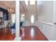 Bright foyer featuring hardwood floors, a decorative chandelier, and elegant architectural details at 521 Mirramont Pl, Woodstock, GA 30189
