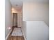 Long hallway featuring hardwood floors and light neutral walls at 521 Mirramont Pl, Woodstock, GA 30189