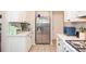 Well-appointed kitchen with stainless steel refrigerator, white cabinets, and plentiful countertop space for meal preparation at 521 Mirramont Pl, Woodstock, GA 30189