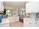 Well-lit kitchen features white cabinetry, stainless steel appliances, and an open floor plan at 521 Mirramont Pl, Woodstock, GA 30189