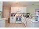 Well-lit kitchen with ample counter space, white cabinetry, and modern appliances, perfect for cooking and meal preparation at 521 Mirramont Pl, Woodstock, GA 30189